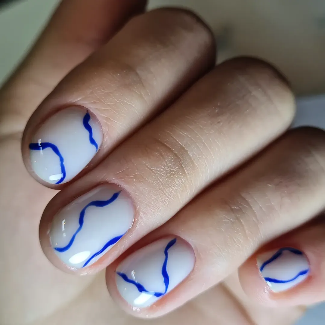 Abstract Blue Swirls on Milky White Short Nails
