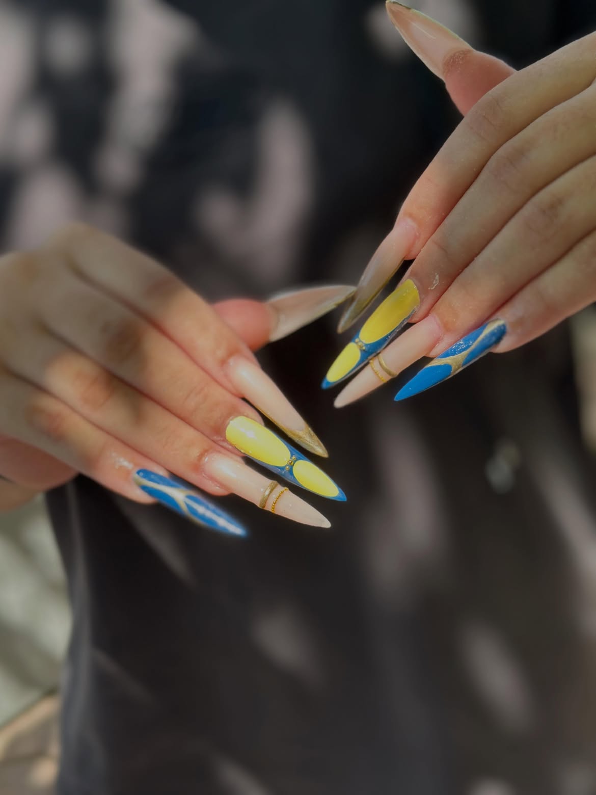 Bold Blue Yellow Stiletto Nails with Gold Accents