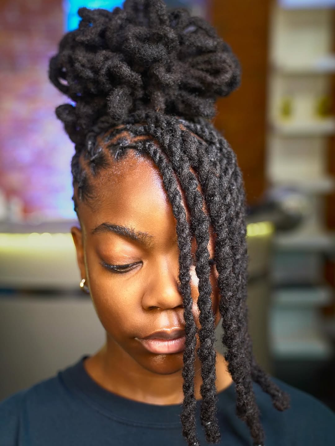 Braided Dreadlocks With High Bun And Face Framing Strands