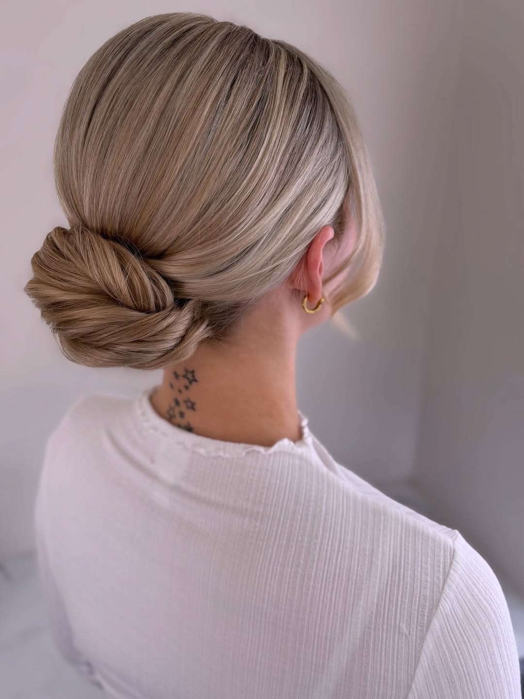 Chic Low Twisted Bun With Face Framing Strands