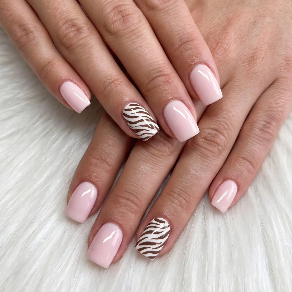 Chic Zebra Print Accents on Soft Pink Nails