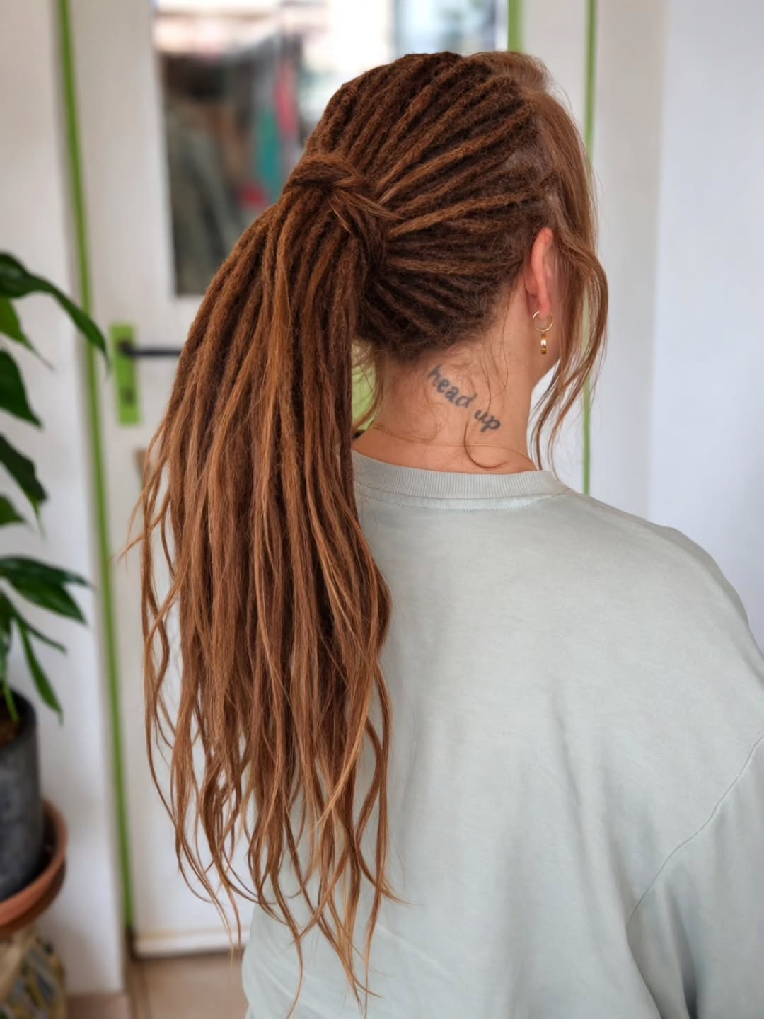 Copper Locs Styled In A High Ponytail