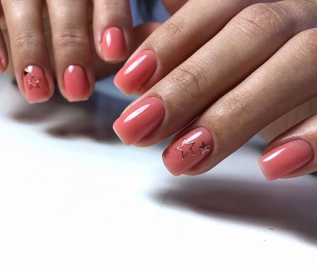 Coral Pink Glossy Nails with Gold Stars