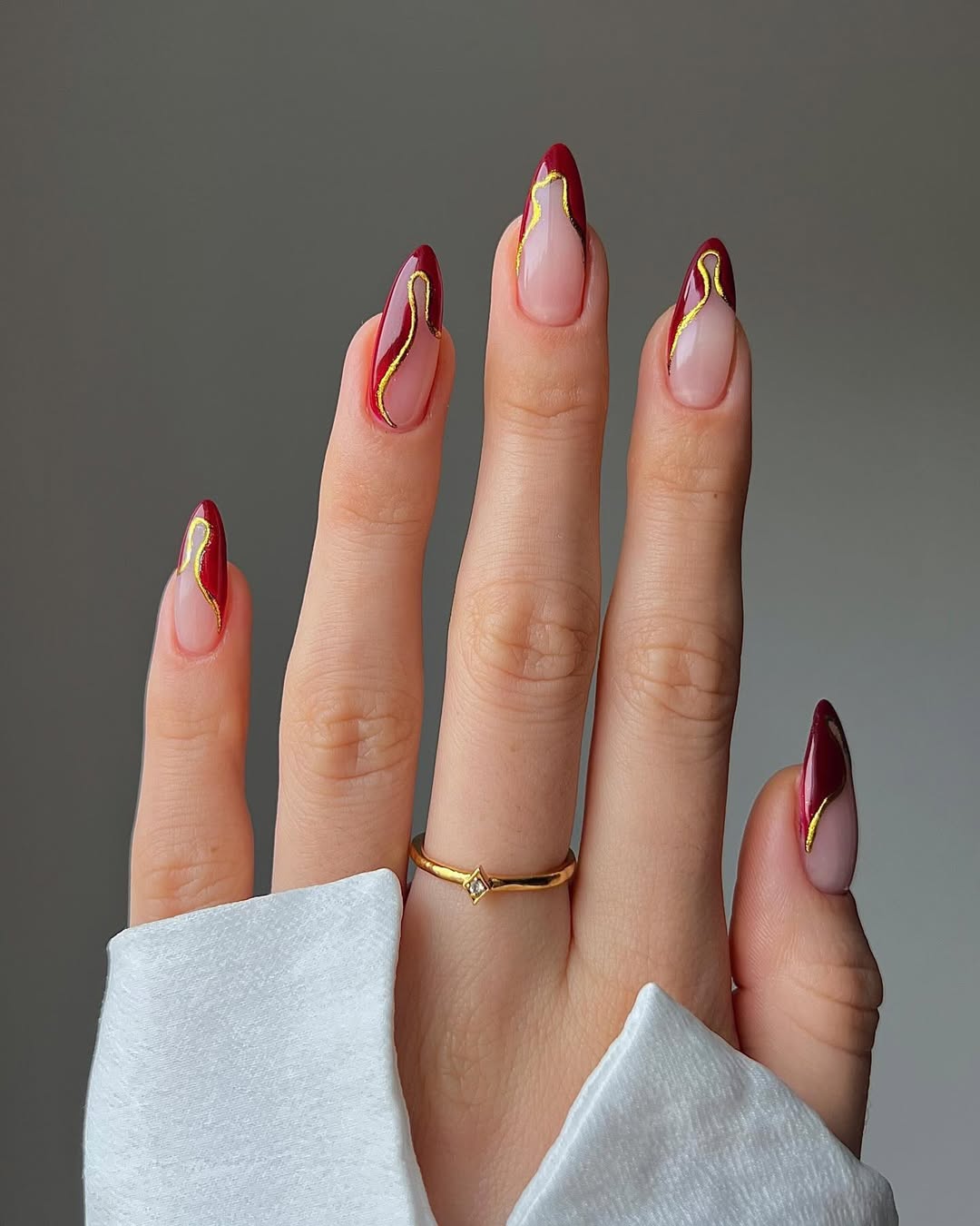 Deep Red And Gold Abstract Almond Nails
