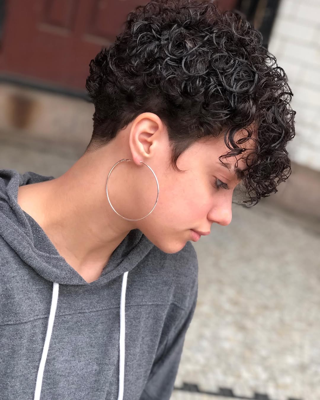 Defined Curly Pixie Cut With Tapered Sides