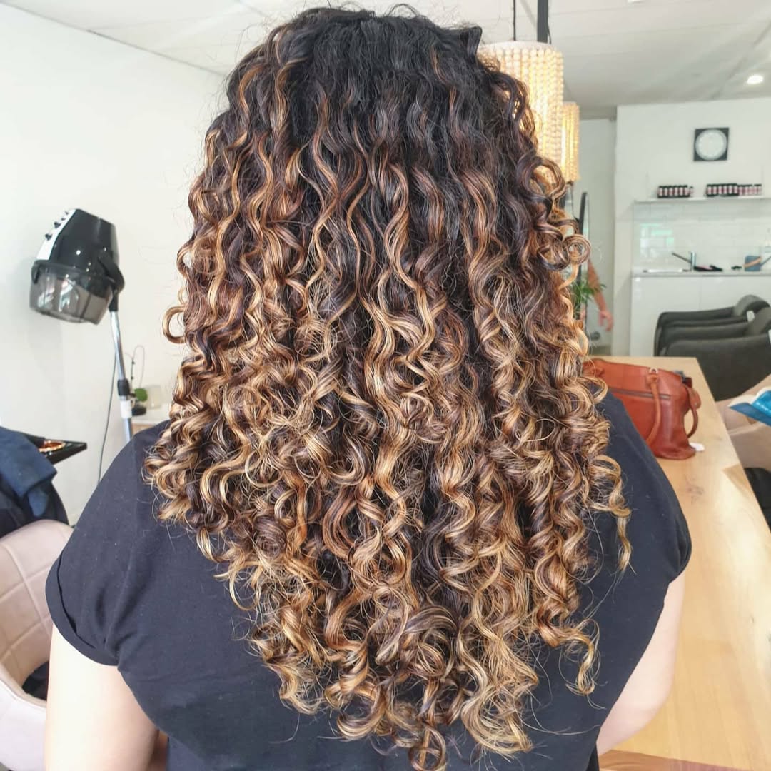 Eclectic Honey Blonde Curls With Rich Brown Roots