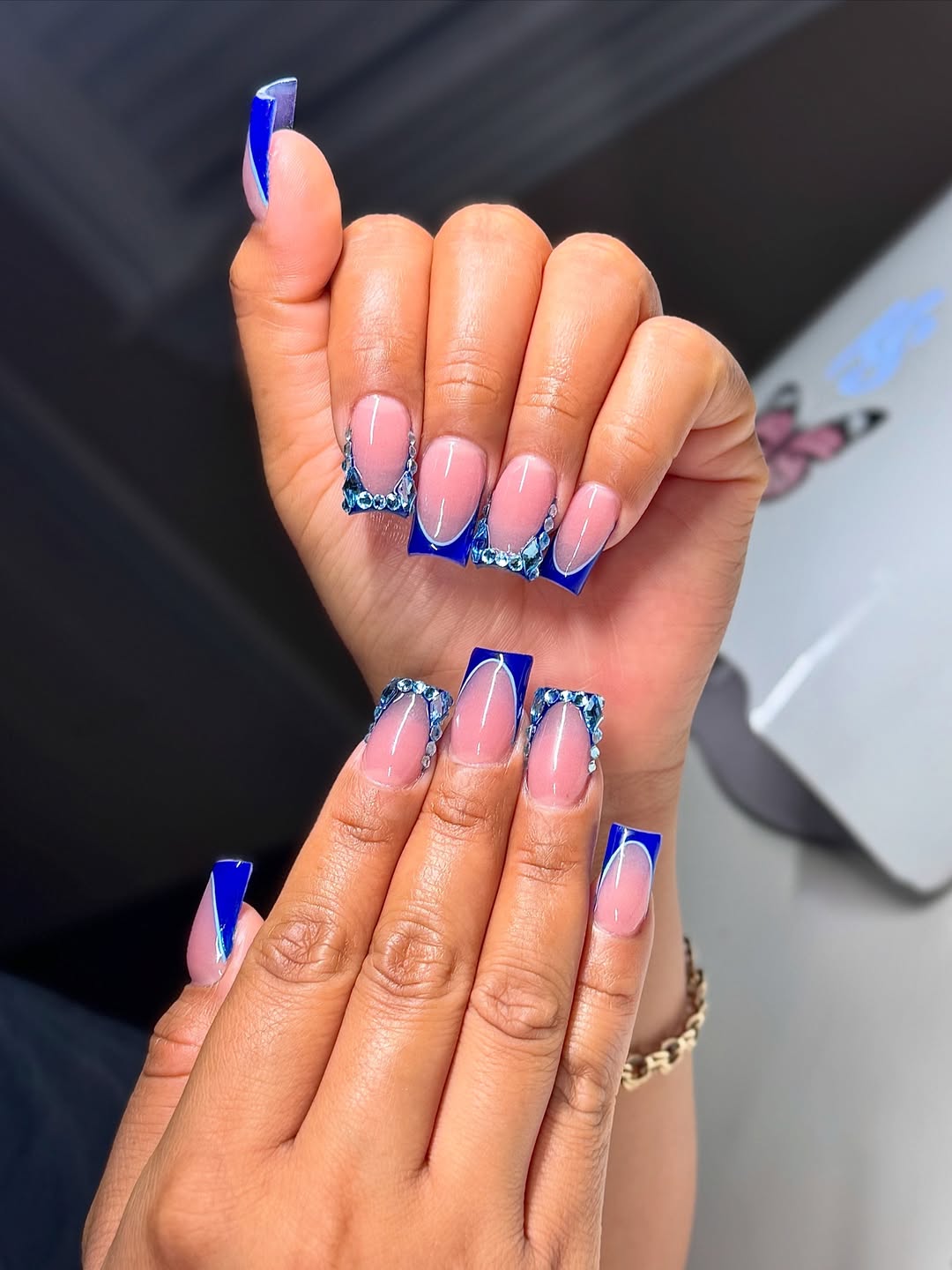 Electric Blue French Tip Nails with Rhinestone Embellishments