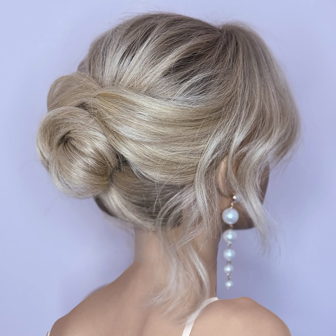Elegant Blonde Chignon With Loose Face-Framing Waves