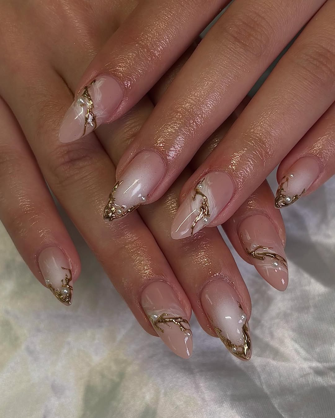 Elegant Gold Swirl French Tip Almond Nails
