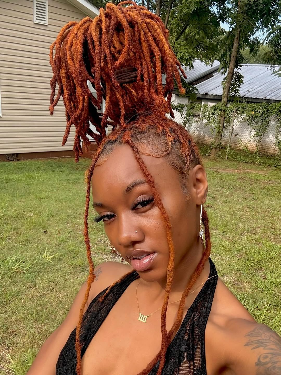 Fiery Copper Dreadlocks Styled in a High Bun