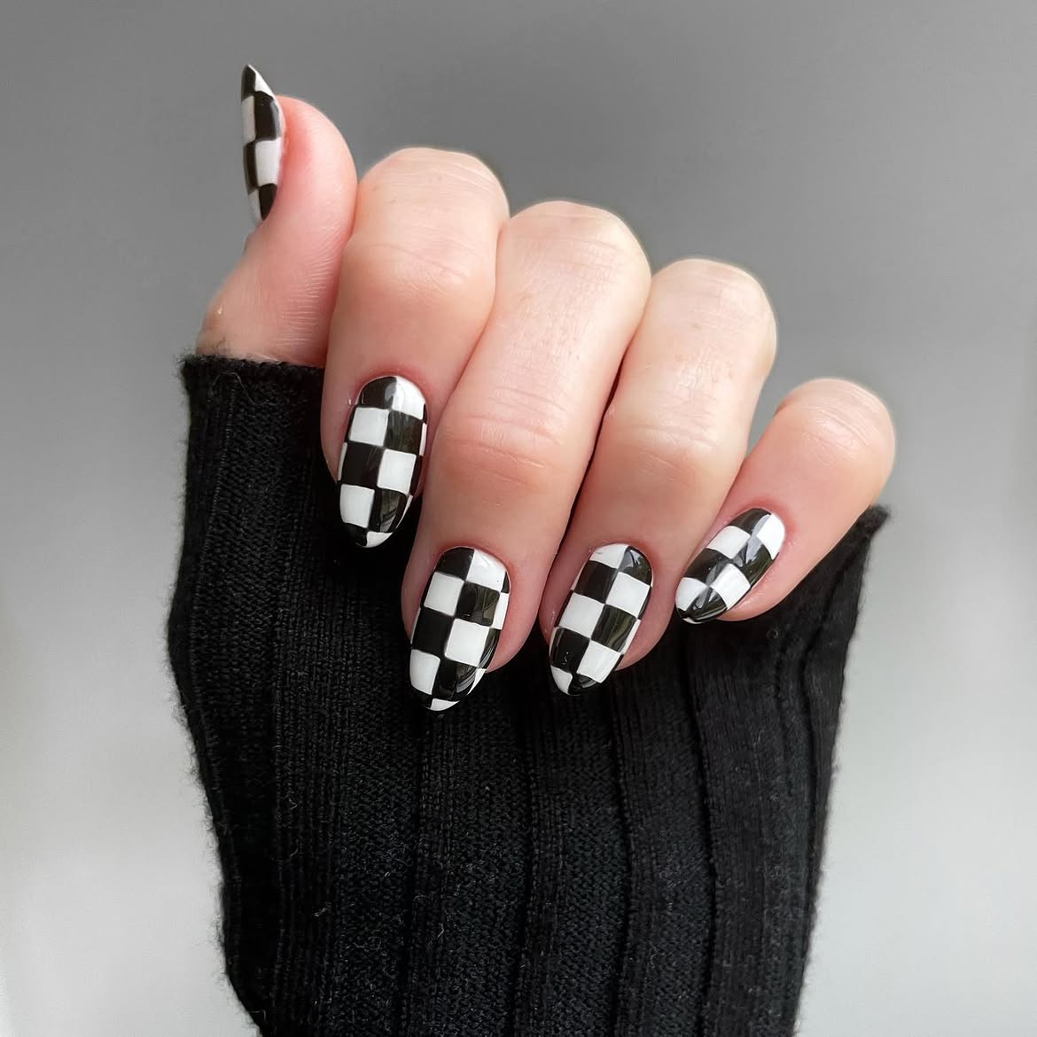 Glossy Black and White Checkerboard Almond Nails