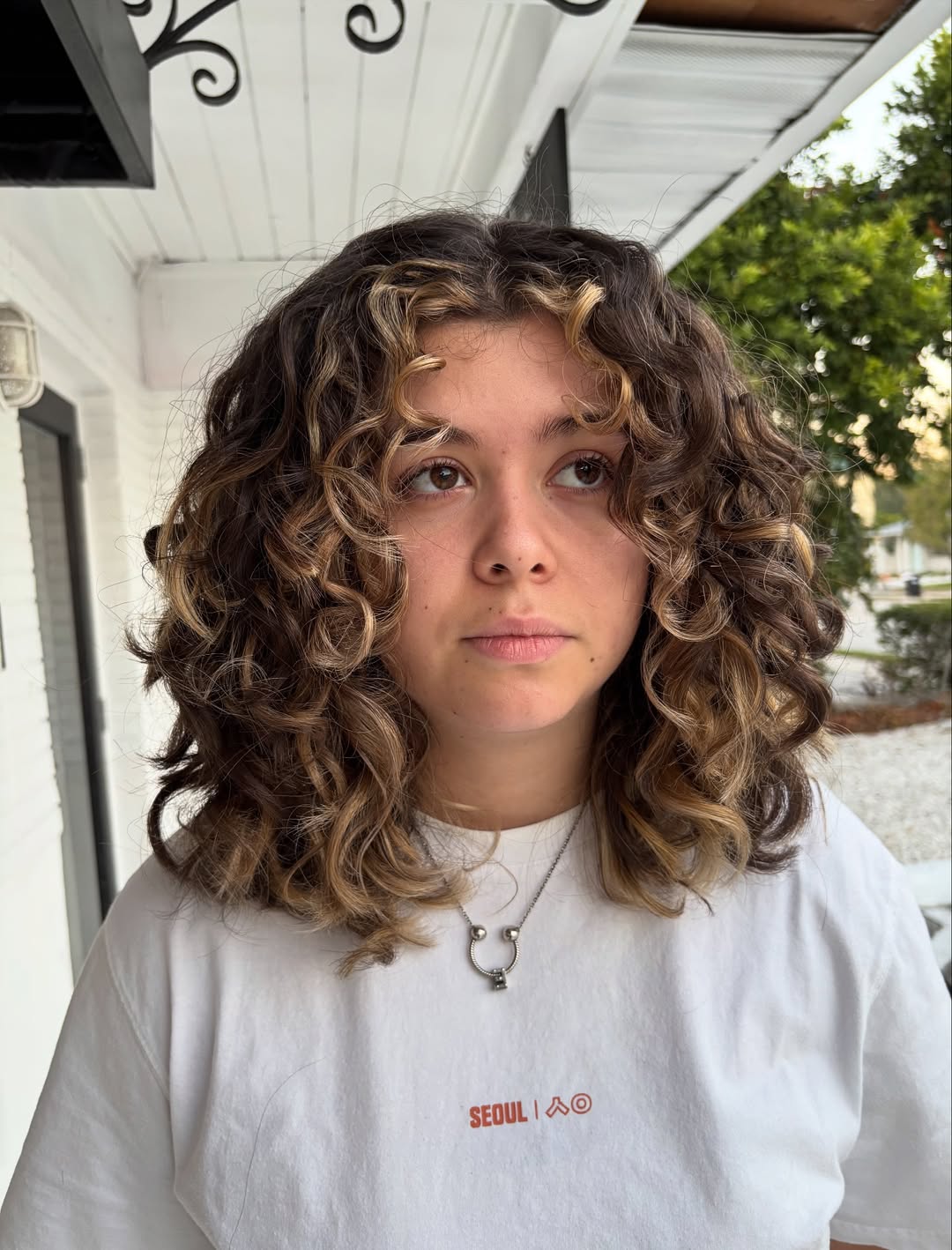Honey Blonde Balayage On Medium Curly Cut
