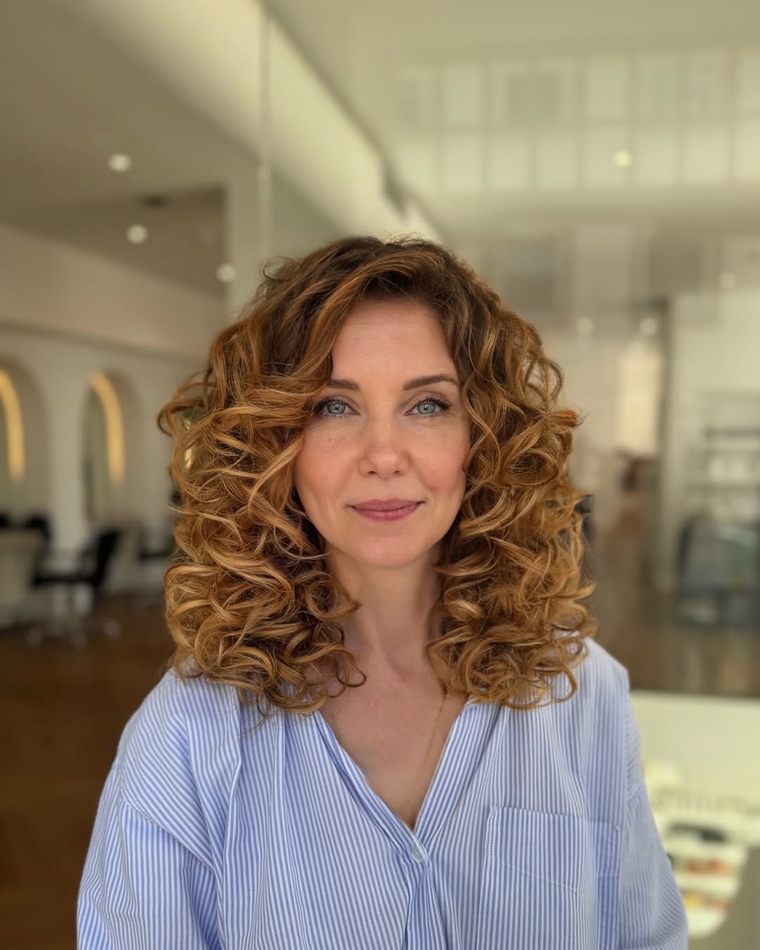 Honey Blonde Curls With Face-Framing Layers