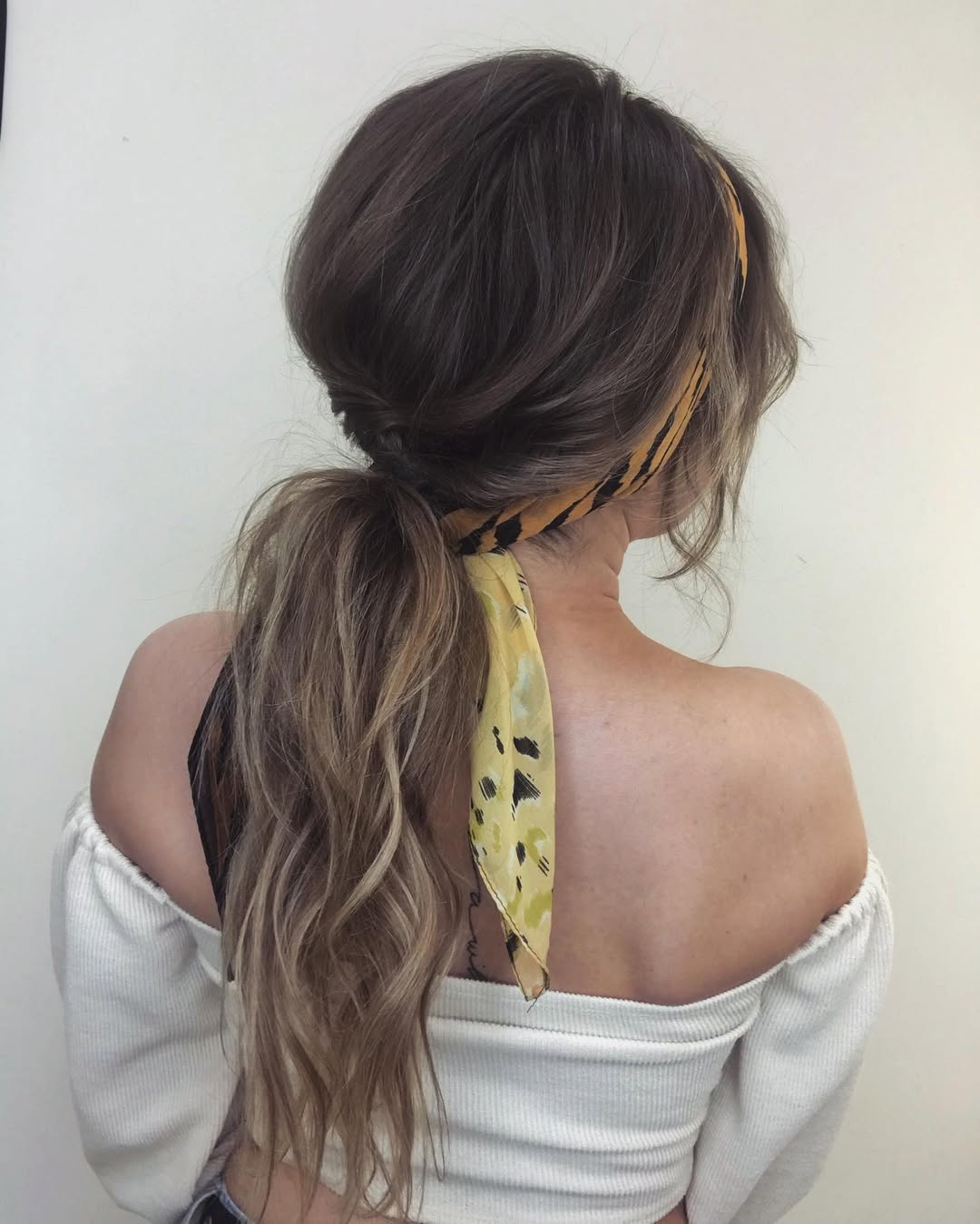 Low Ponytail With Textured Waves and Scarf Accent