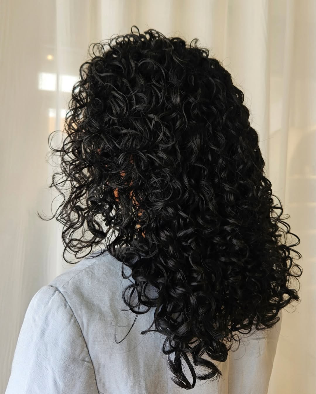 Lush Black Curly Shoulder-Length Cut