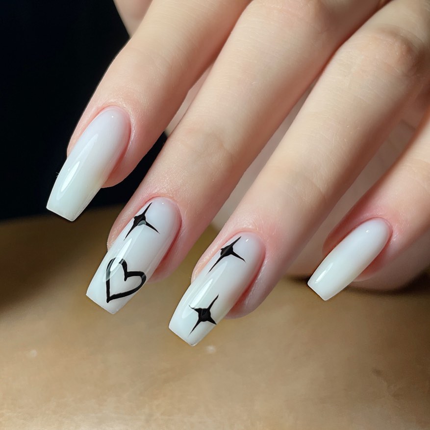 Milky White Ballerina Nails with Black Heart and Stars