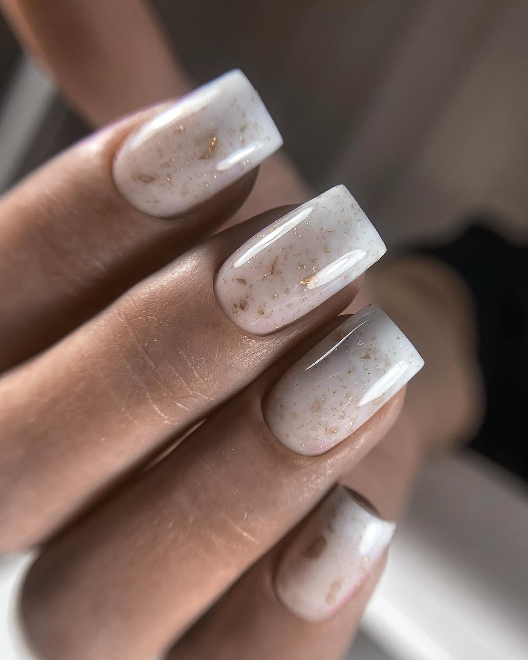 Milky White Nails With Gold Flakes Accent