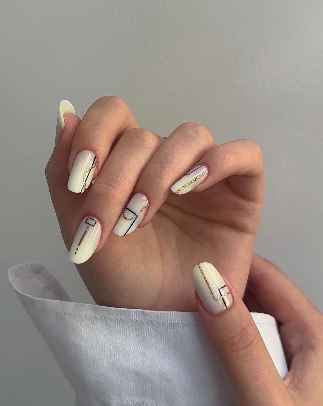 Modern White Geometric Gold Line Almond Nails