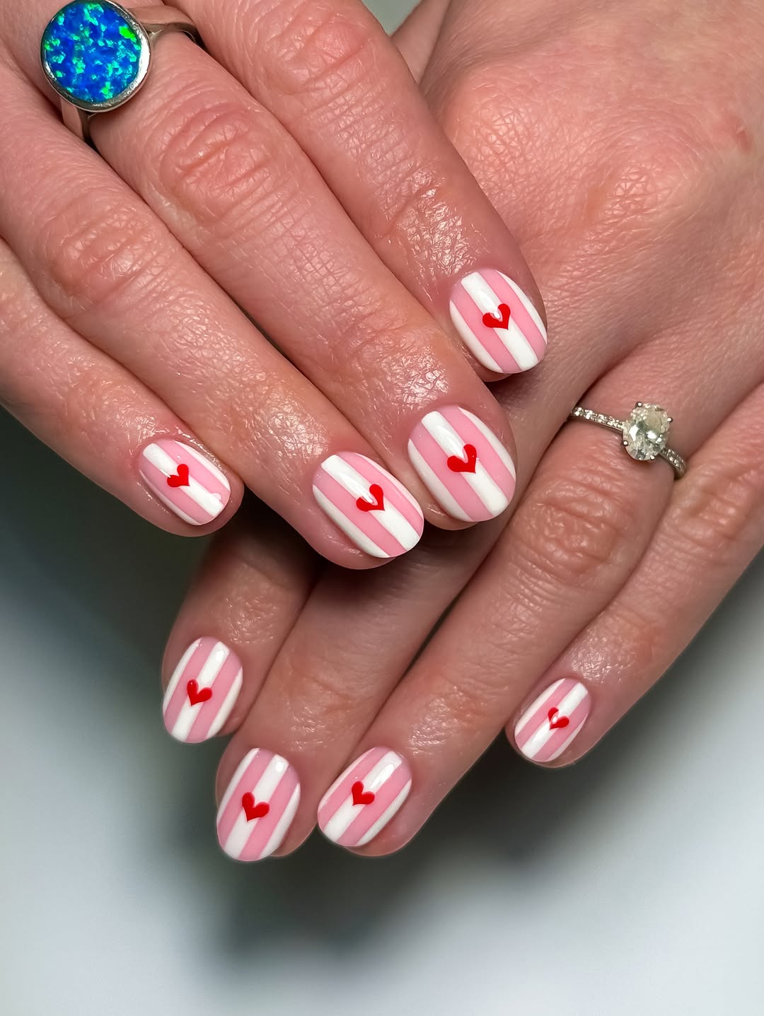 Pink and White Striped Short Nails with Red Hearts