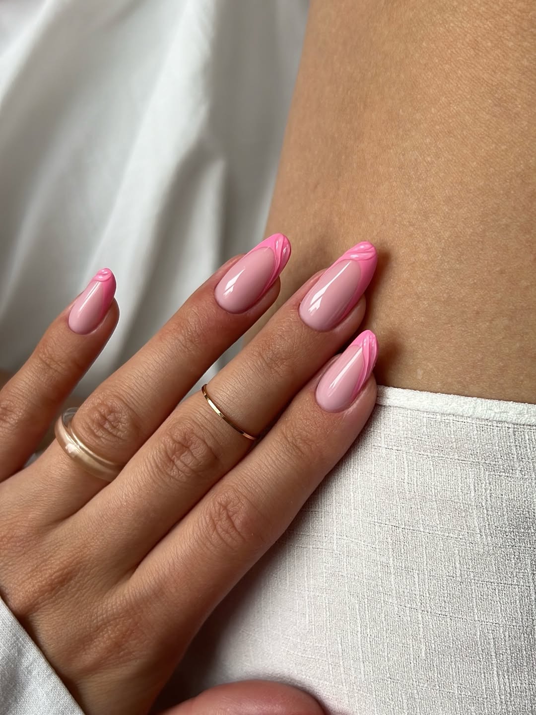 Pink French Tip Almond Nails with Swirl Detail