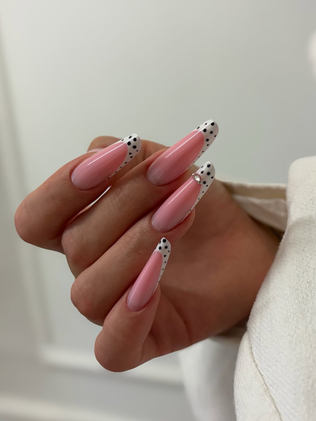 Pink French Tip Nails with Polka Dot Accent