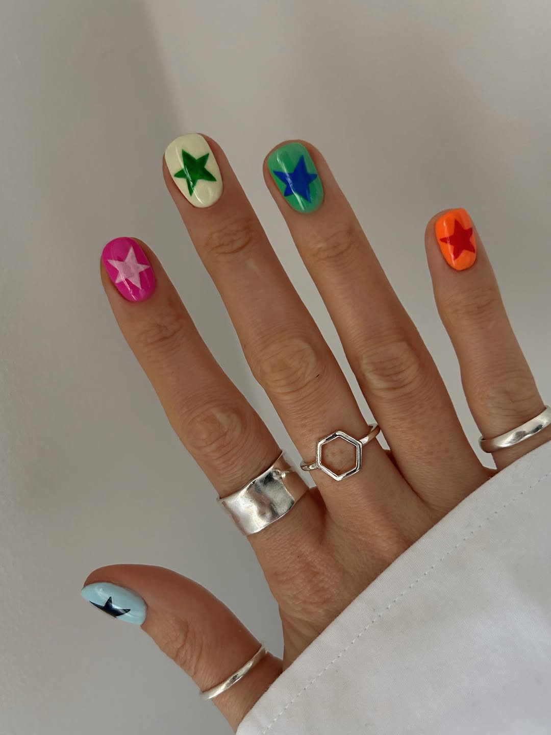 Playful Star Accents on Short Glossy Nails