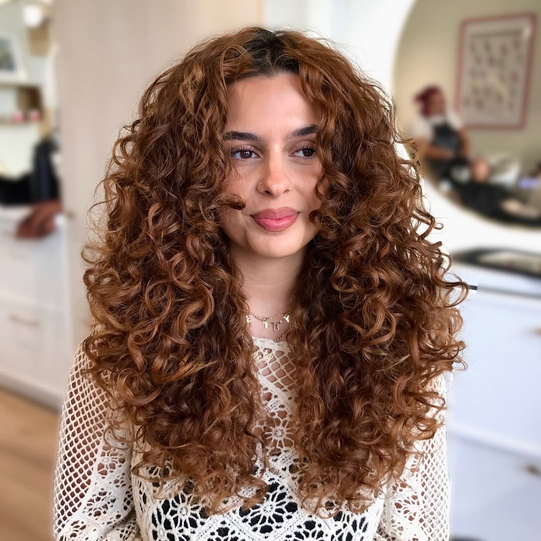 Rich Auburn Curly Cut With Face Framing Layers