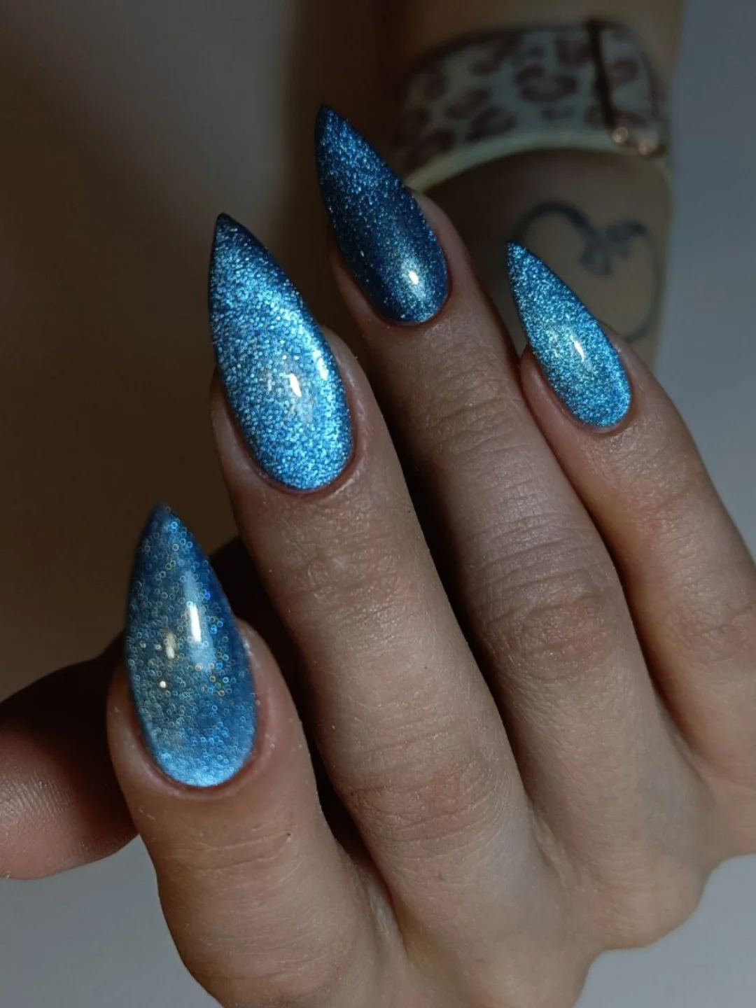 Shimmering Blue Cat Eye Stiletto Nails
