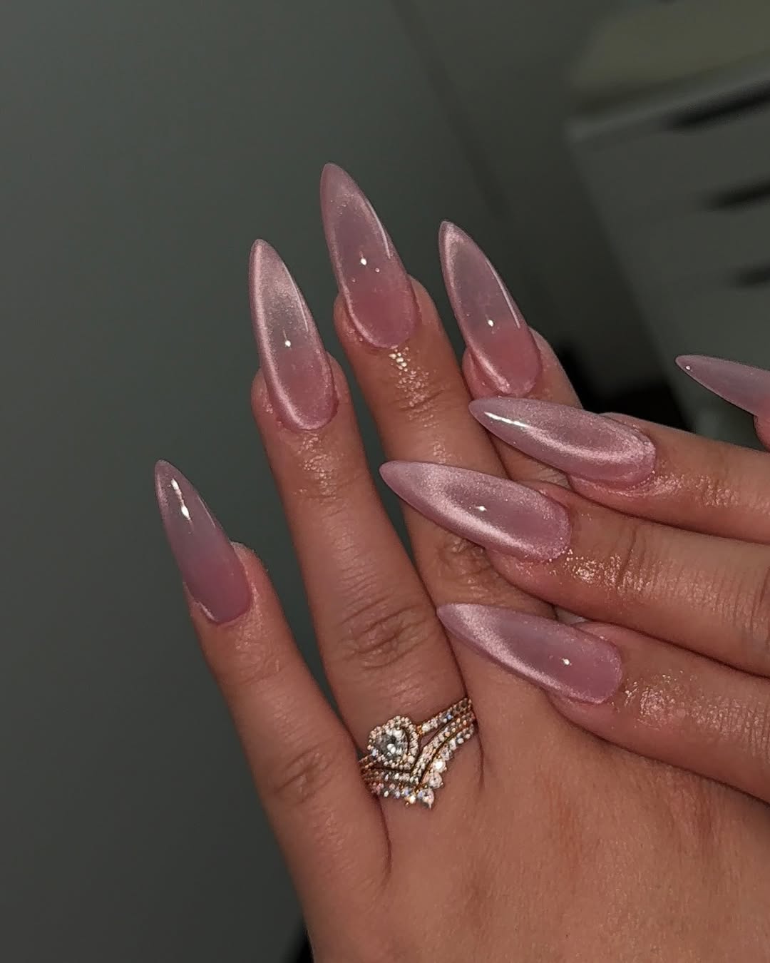Shimmering Rose Gold Cat Eye Almond Nails