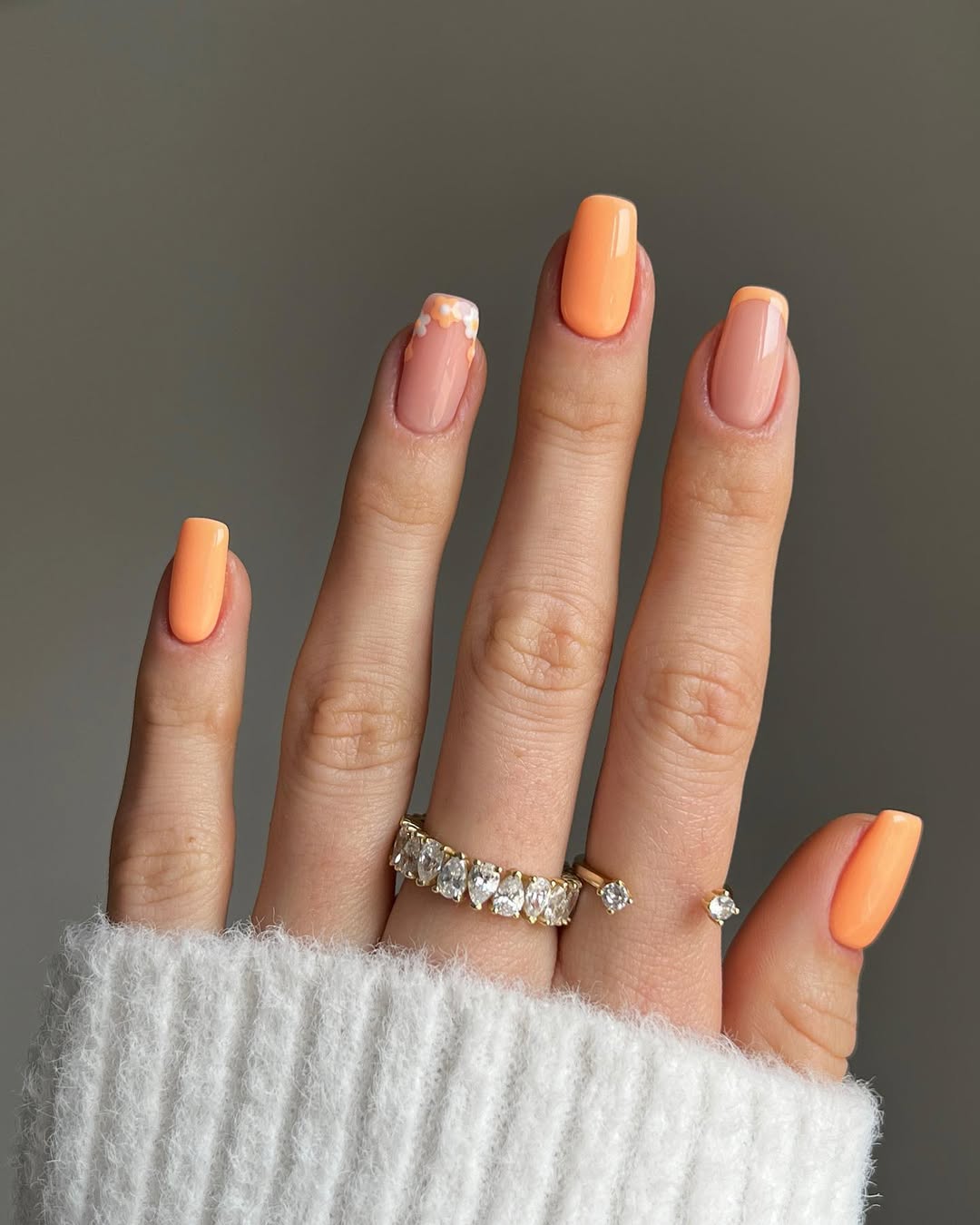 Soft Peach French Manicure with Delicate Floral Accents