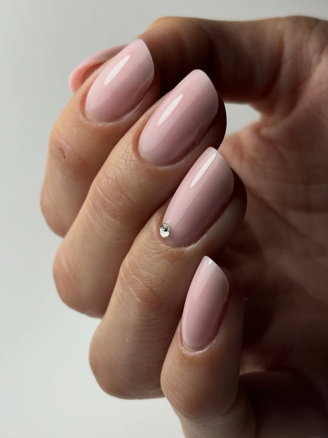 Soft Pink Milky Oval Nails With Single Crystal Accent