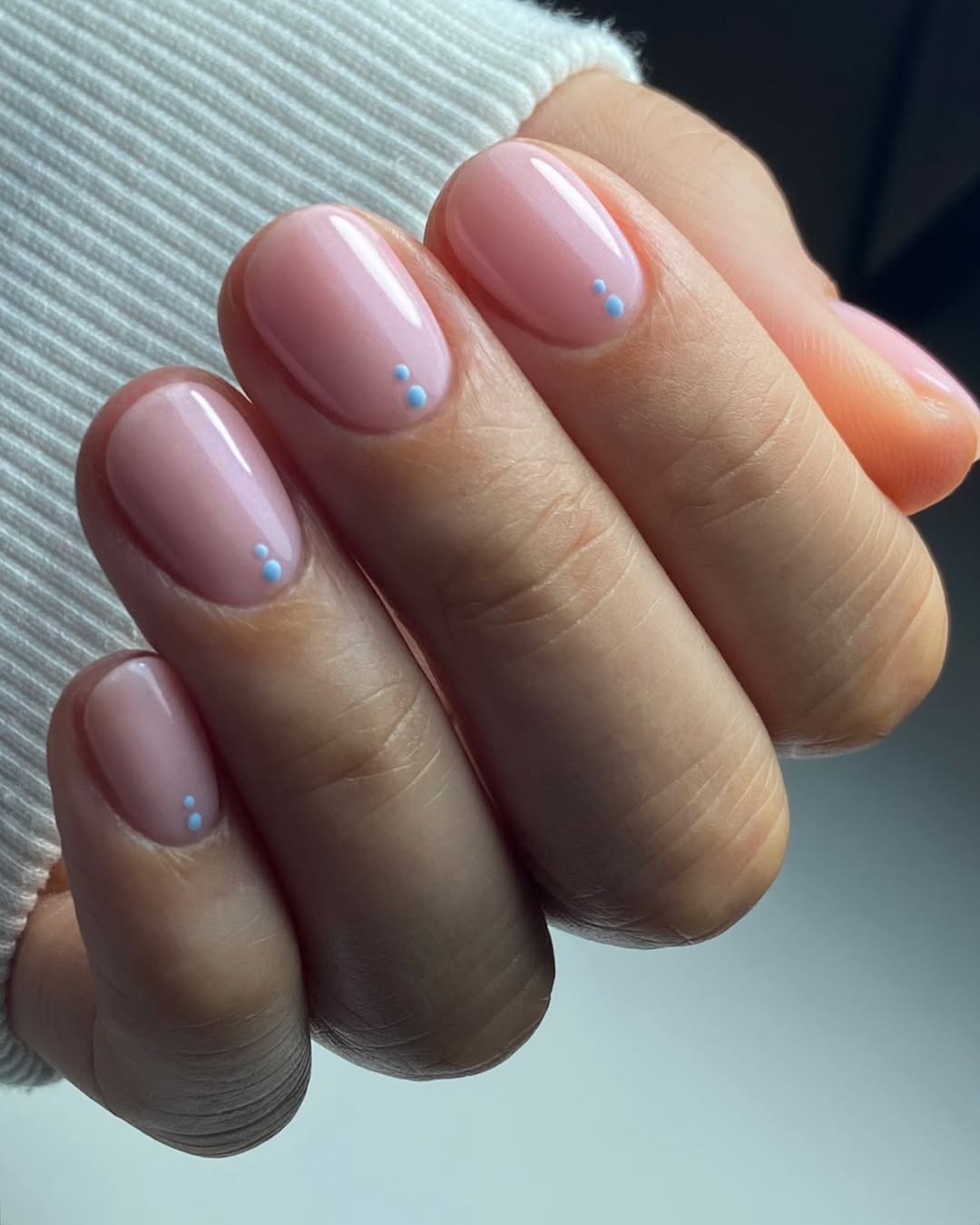 Soft Pink Oval Nails with Subtle Blue Dot Accents