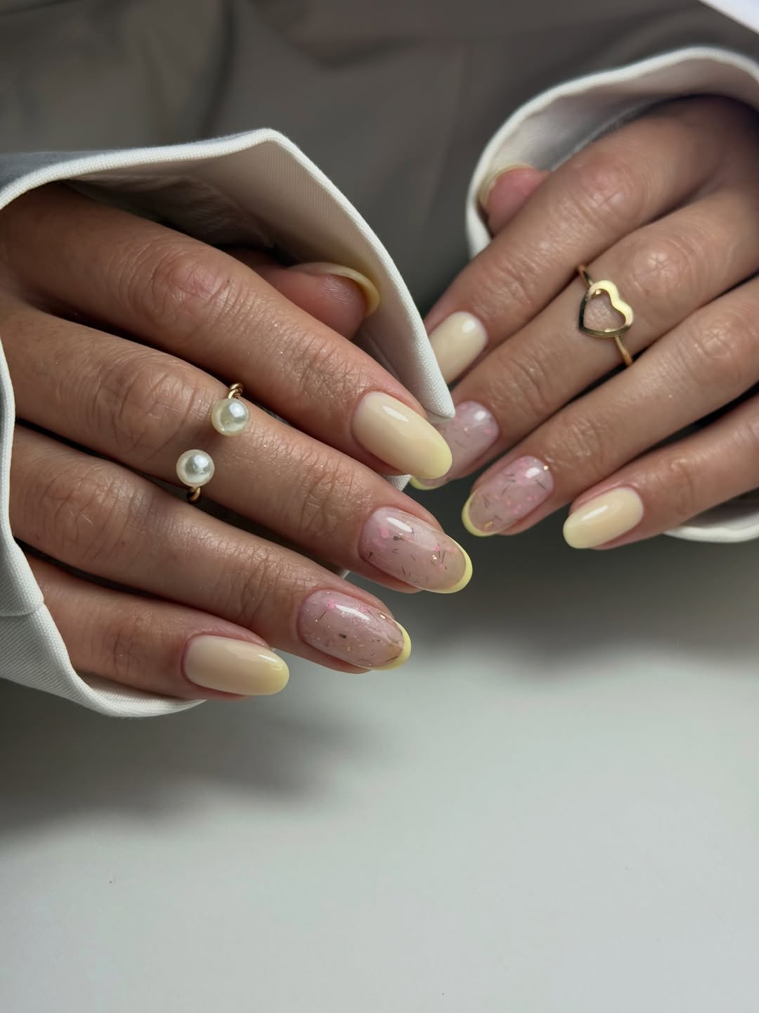 Soft Yellow French Oval Nails with Glitter Accents