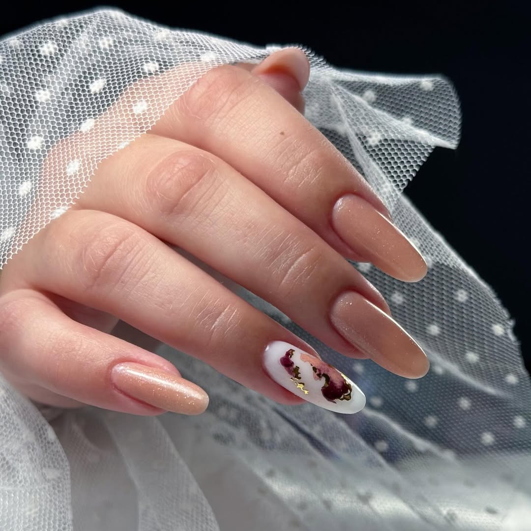 Sparkling Nude Aura Oval Nails with Gold Foil Accents