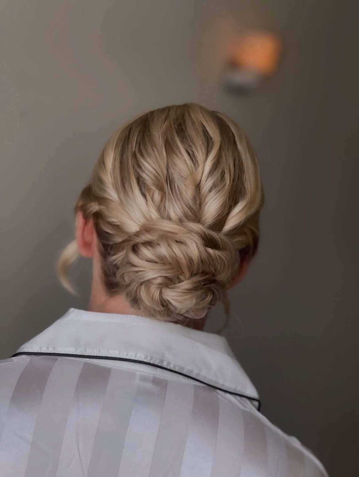 Twisted Low Chignon With Loose Honey Blonde Strands