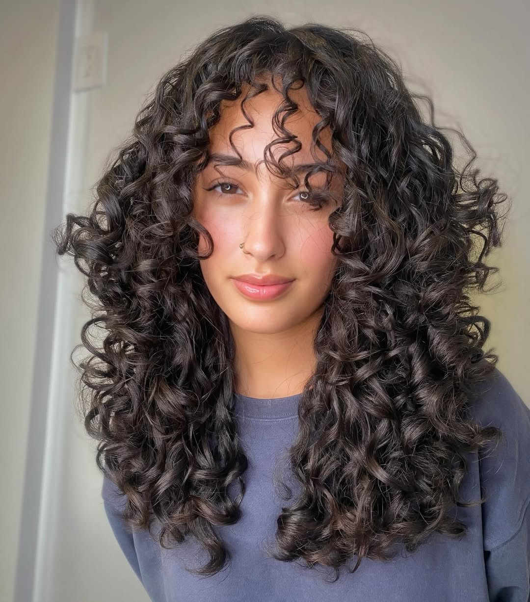 Voluminous Curly Cut With Face-Framing Layers