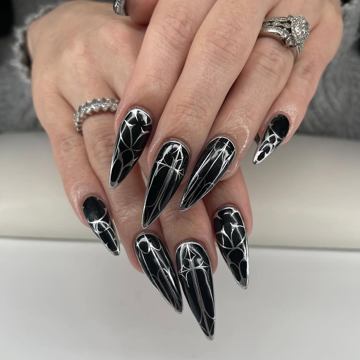 Black Stiletto Nails with Silver Gothic Cross Art