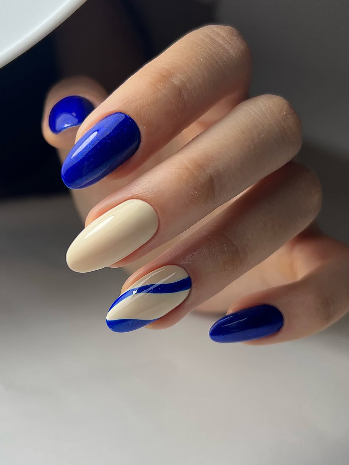 Blue and Cream Abstract Swirl Almond Nails