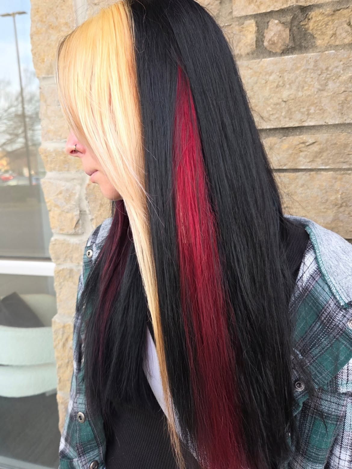 Bold Black and Blonde Split Hair with Red Streaks