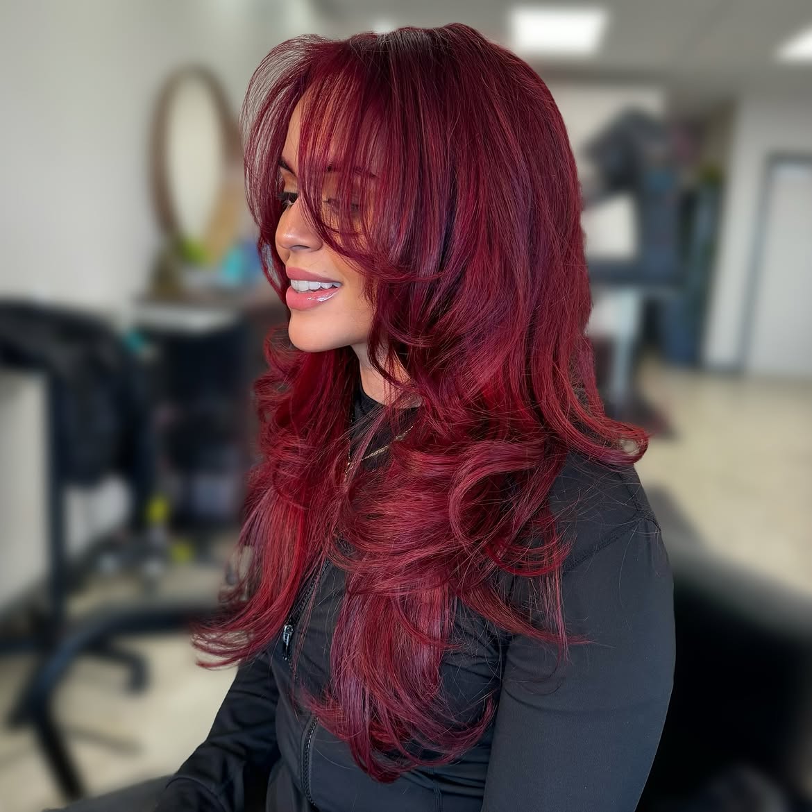 Bold Cherry Red Layers With Face-Framing Bangs