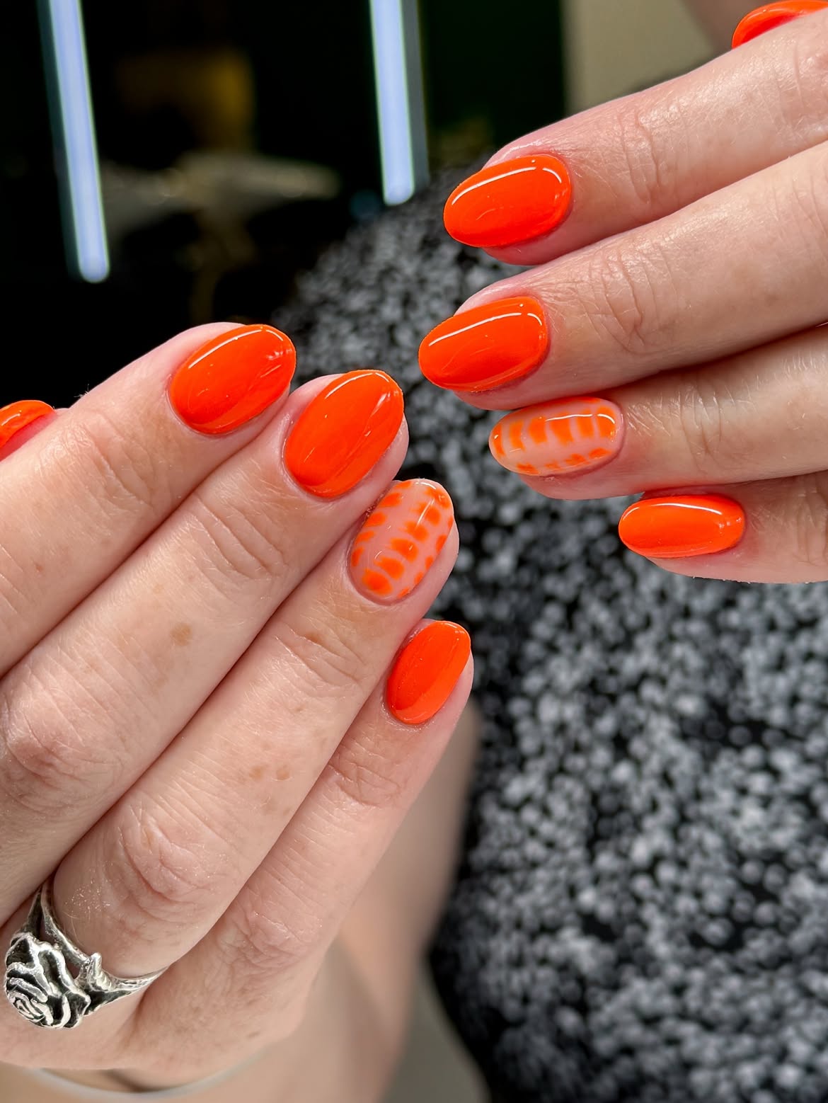 Bright Neon Orange Oval Nails with Abstract Art