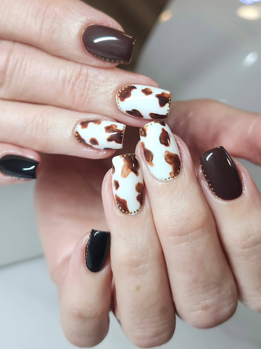 Cow Print Nails with Gold Stud Embellishments