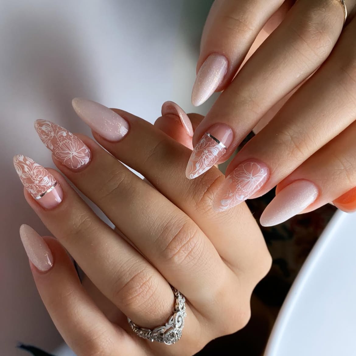 Delicate Lace Almond Nails with Subtle Shimmer