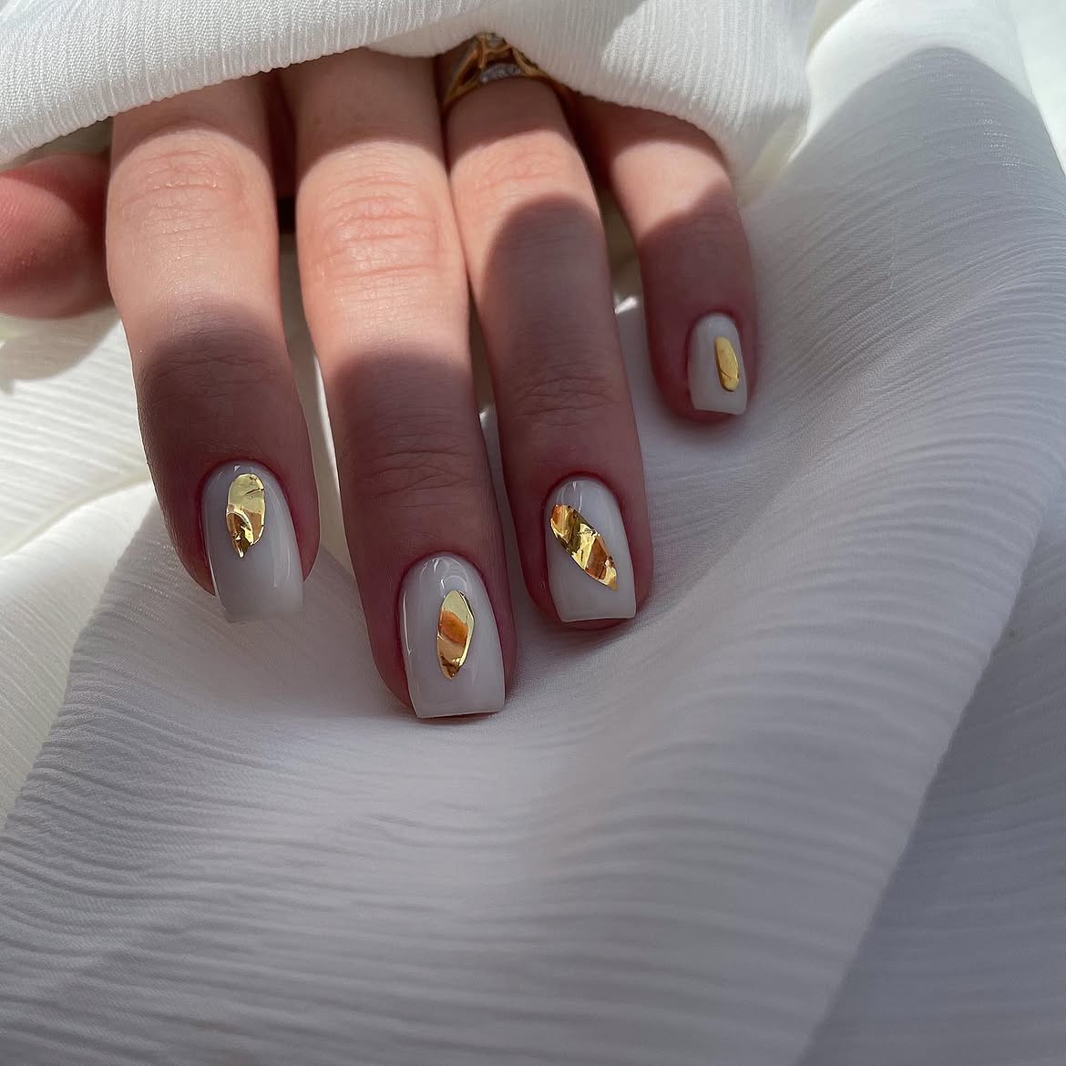 Elegant Milky White Nails with Gold Foil Accents