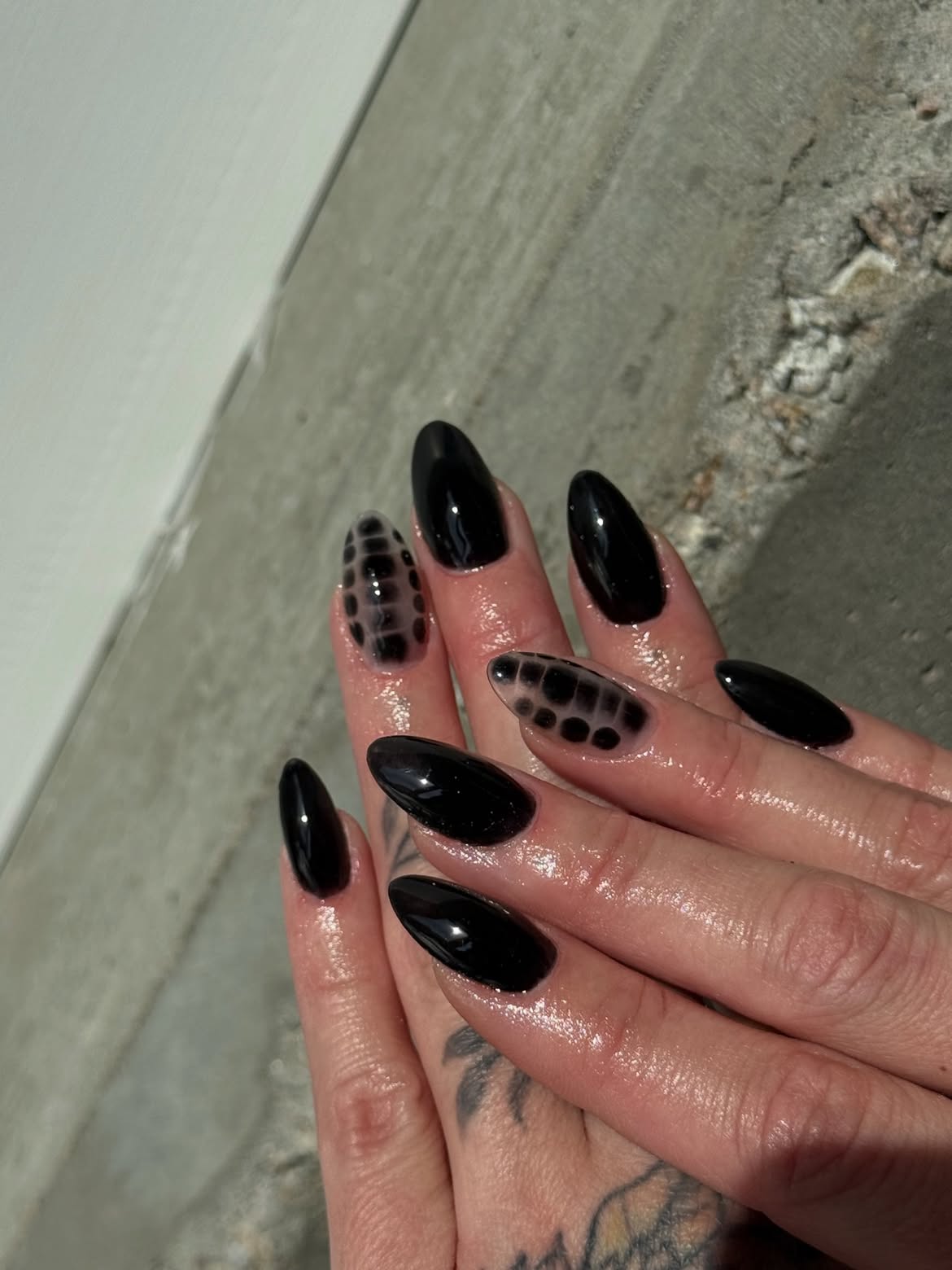 Glossy Black Almond Nails with Transparent Dot Art
