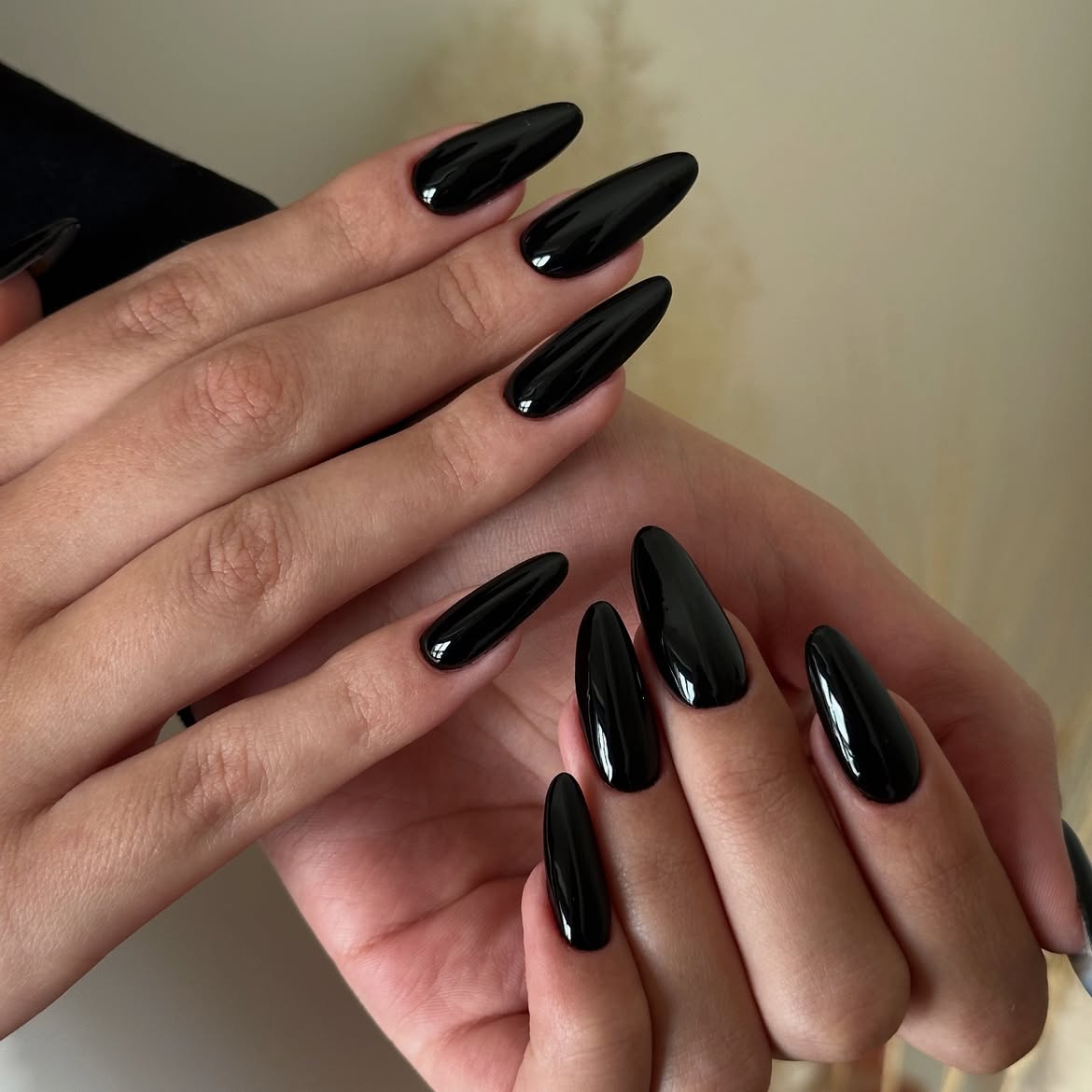 Glossy Black Stiletto Almond Nails