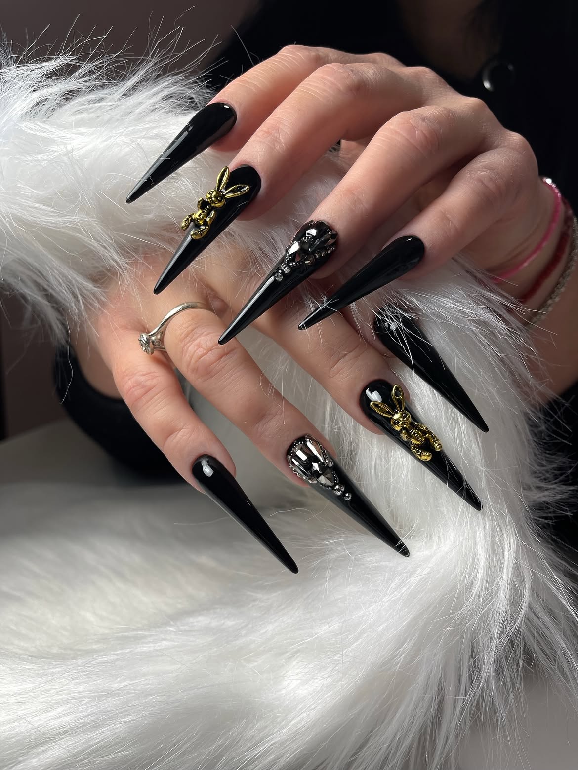 Glossy Black Stiletto Nails with Gold Bunnies and Skulls