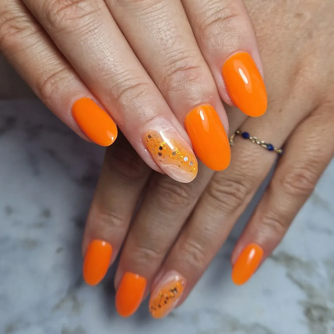 Glossy Bright Orange Oval Nails with Glitter Accent