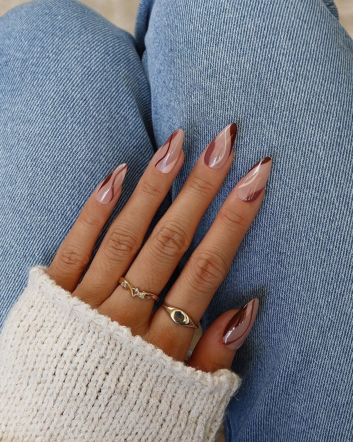 Glossy Brown Swirl Almond Nails With Nude Base
