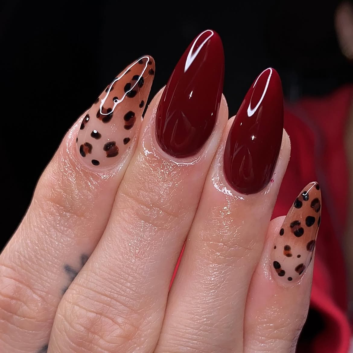 Glossy Deep Cherry Red And Leopard Print Almond Nails